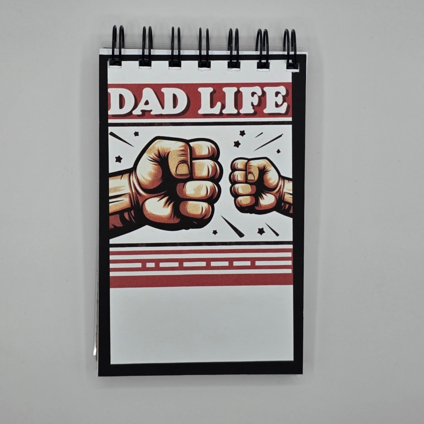 Notebook with 'Dad Life' design featuring two fists on a gray background
