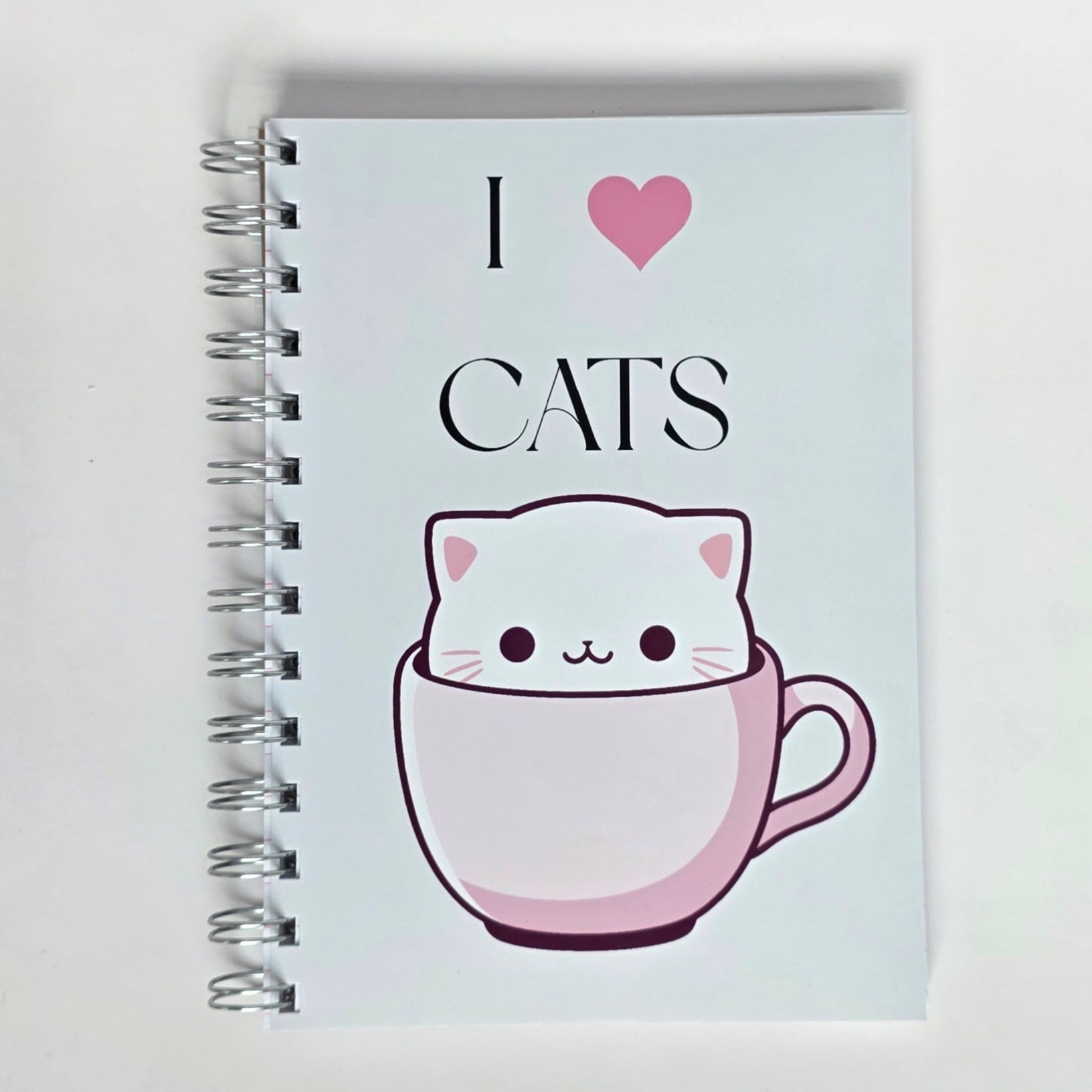 Cute cat notebook with “I Love Cats” text and white cartoon cat in pink teacup on glossy cover