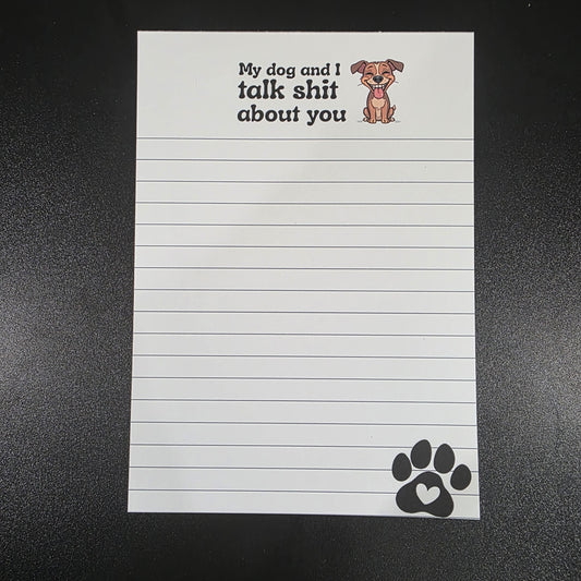 Notepad with lined pages and humorous text on a black background